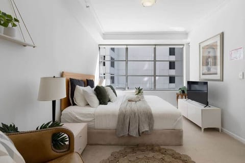 The master bedroom with a king sized bed and a 40 inch TV.