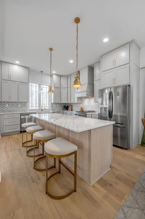 Make a grand entrance in our stunning entryway, featuring white oak floors and a warm, welcoming ambiance.