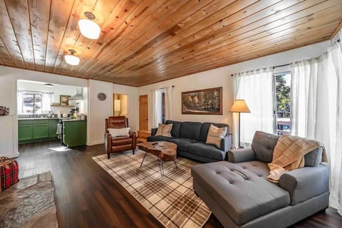 A cozy and comfortable living room with chaise lounge, gas fireplace, and smart tv.