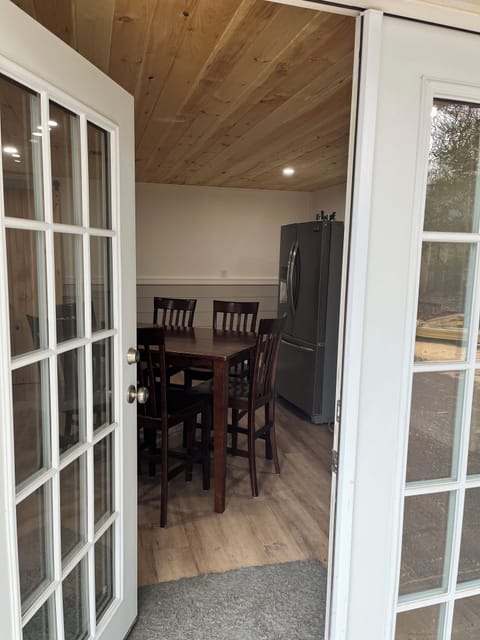 Newly finished lower level entry. Full refrigerator & table for games or eating.