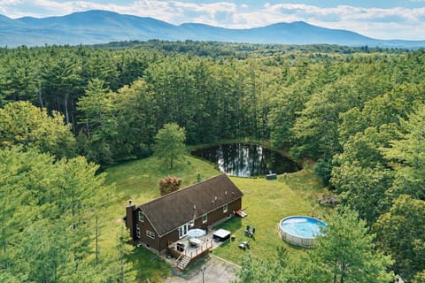 Aerial view of a Catskills Cabin with pool and pond in summer