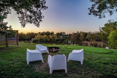 Fire pit, putting green, and Long Creek at sunset, all from the same spot in the yard. The Riviere Skoolie on Lake Granbury packs more into a small footprint than most full-size vacation rentals near Fort Worth, TX.