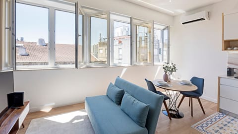This bright and airy living space invites you to relax on the comfortable sofa, enjoy a meal at the dining table, or simply take in the city views through multiple tilt-and-turn windows. Natural light floods the room, creating a serene and inviting atmosp