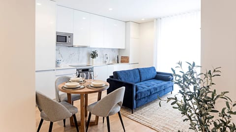 Main area with a kitchenette, sofa bed and dining area #lovelystay
