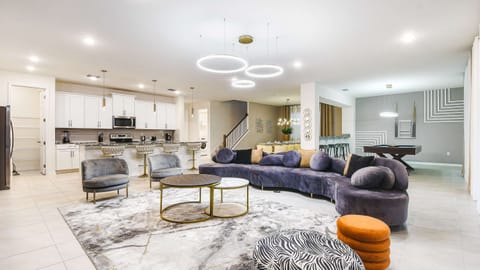 Spacious modern retreat with open kitchen, elegant lounge, and pool table.