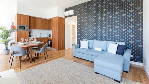 Gather with loved ones in this stylish open-plan space, perfect for cooking delicious meals in the well-appointed kitchen or unwinding on the comfortable sofa after a day of exploring. The vibrant accent wall adds a touch of charm to your stay.