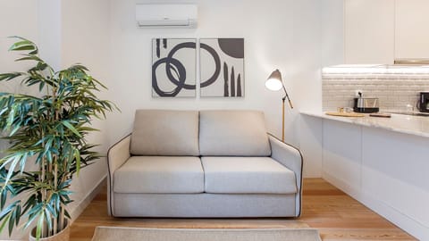 Sofa, painting and plant details.