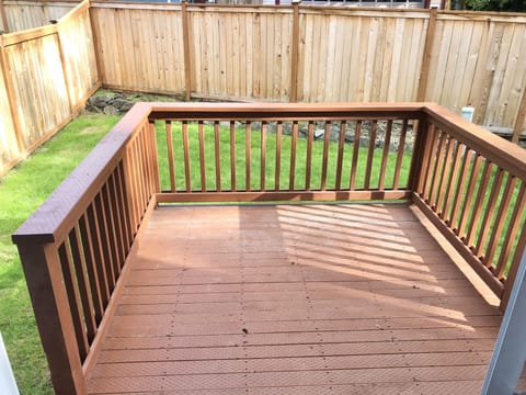 Backyard patio and a fully fenced back yard.