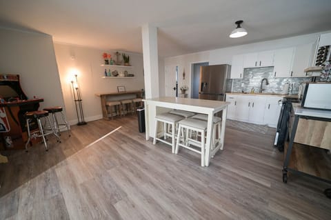 A dream kitchen with stainless steel appliances, and white cabinets, perfect for cooking and entertaining guests.