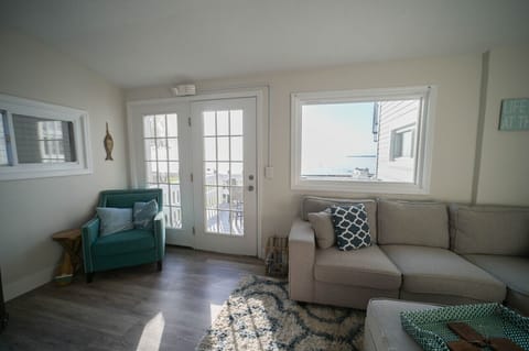 A modern living room with a sectional sofa, rug, coffee table, and TV, perfect for relaxing and unwinding after a long day.
