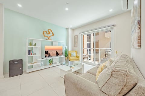 A cozy spot to relax after a day at the beach, complete with a Smart TV and balcony access.