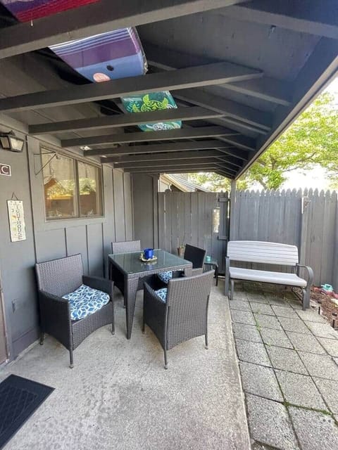fenced patio area with seating & grill