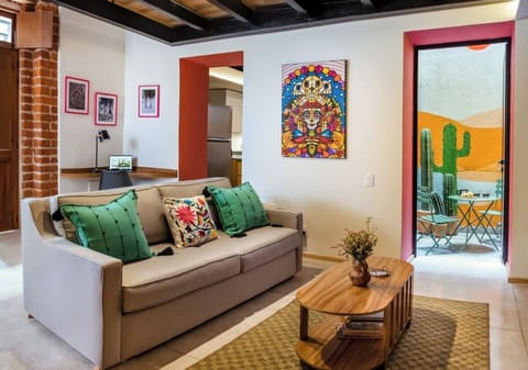 Our stylish living room opens up to a beautiful terrace, where you can admire the breathtaking Oaxaca-style mural. The terrace is the perfect spot to relax and unwind while soaking up the sun or enjoying a drink with friends.