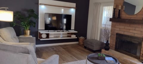 Comfortable Living Room features a Leather Sofa and 2 Chairs and Ottoman.