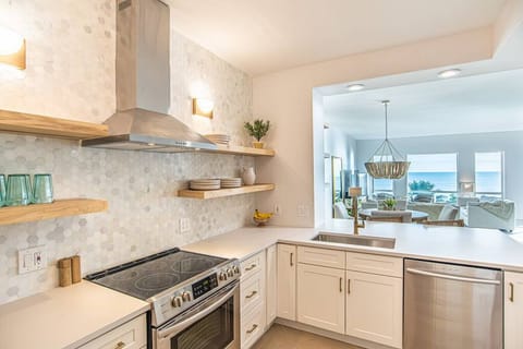Kitchen with a full pantry and full-size washer and dryer combo.
