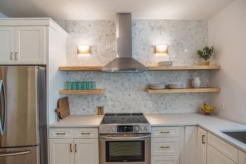 Kitchen with a full pantry and full-size washer and dryer combo.