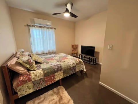 Main bedroom with queen bed and TV.