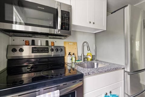 Microwave, stove, oven, and full size refrigerator in the kitchen