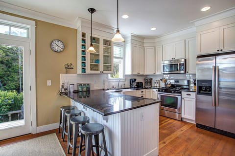Full-stocked kitchen with stainless steel appliances and granite countertops