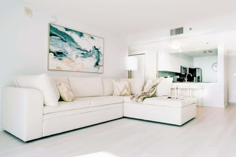 Living room enriched with an abundance of natural light from floor to ceiling window!
