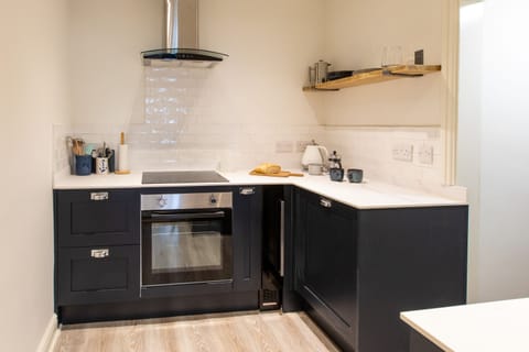 Kitchen with oven, wine chiller, fridge, dishwasher. Utility room to the side