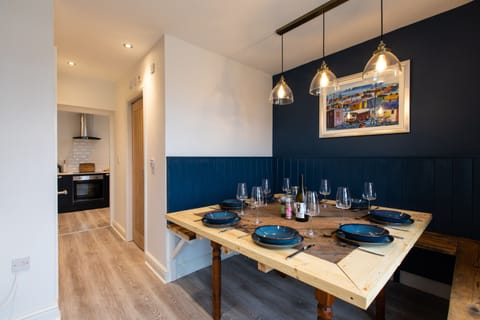 Dining room looking through into the kitchen. Handmade table to seat 8