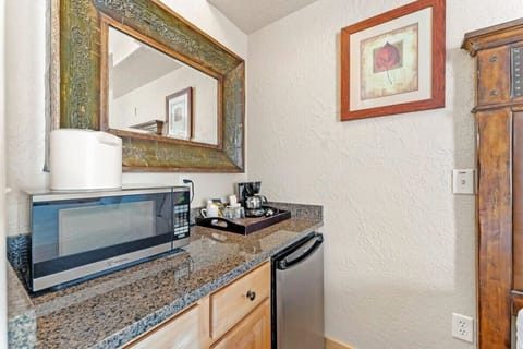 The master bedroom kitchenette includes a microwave, small refrigerator, and a coffee maker.