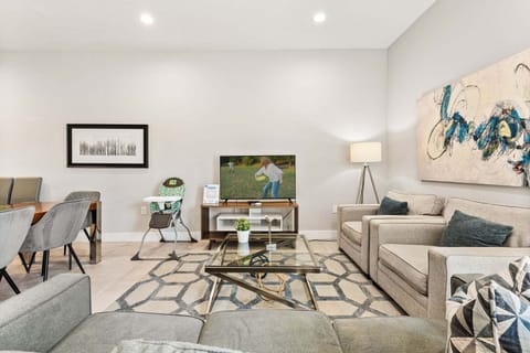 Have a cozy movie night in our living room, featuring a comfy sofa and a large smart TV perfect for relaxing after a day at the parks.