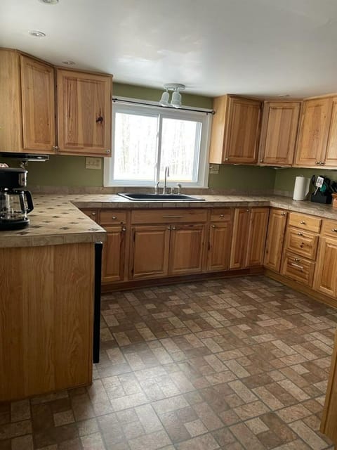 complete with high-quality cookware, a gas range, and cabinet pantry