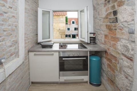 Kitchen with dishwasher, washer, stove, fridge, coffee maker and old town view