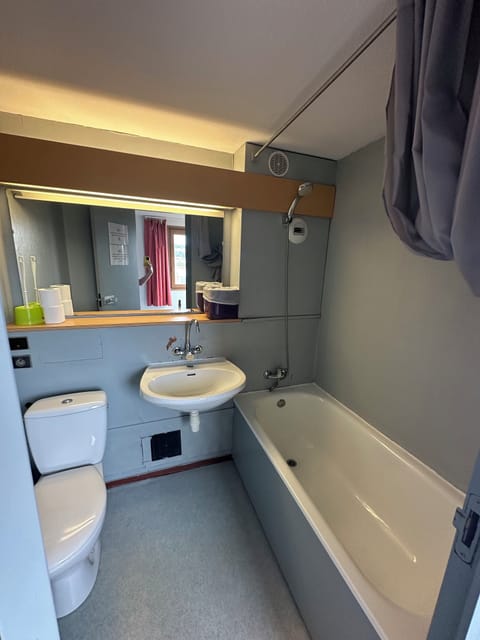 Bathtub, hair dryer, toilet paper