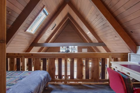 To the left, a daybed. To the right, an office work area.