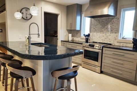 Kitchen bar with 4 stools and sink
