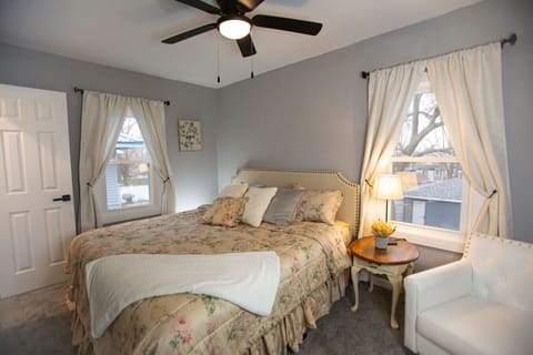 Bedroom 1 with king size bed with sofa chair and lamp