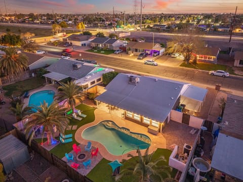 Aerial view of the home, private pool, and full backyard layout at sunset.