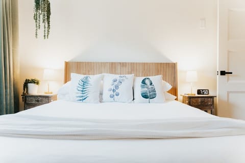 A light-filled queen bedroom overlooking the garden—designed for calm, comfortable stays.