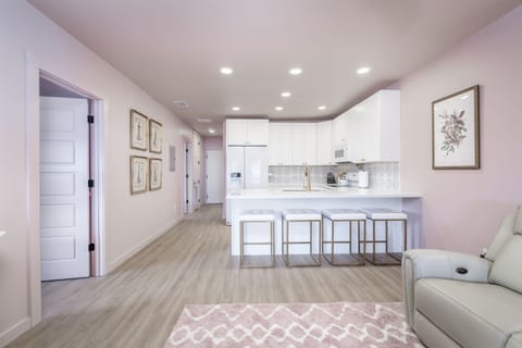 View from the living room into the kitchen and bar seating