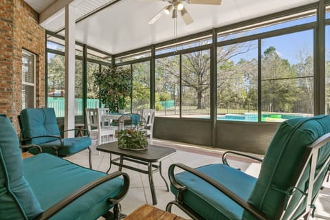Screened Porch: Relax with stunning views, comfy seating, and a splash of fun by the pool!