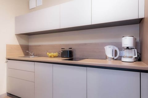 Fully equipped kitchenette with an  induction hob, fridge, freezer, kettle, dishwasher, microwave, toaster, coffee maker and dining area