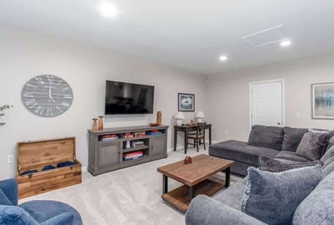 Relax in the spacious living room featuring an ultra-comfy sectional, large TV with Netflix, games, a work desk, and more—perfect for work or play!