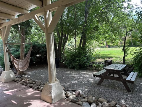 Picnic table and hammock chairs just outside the door.