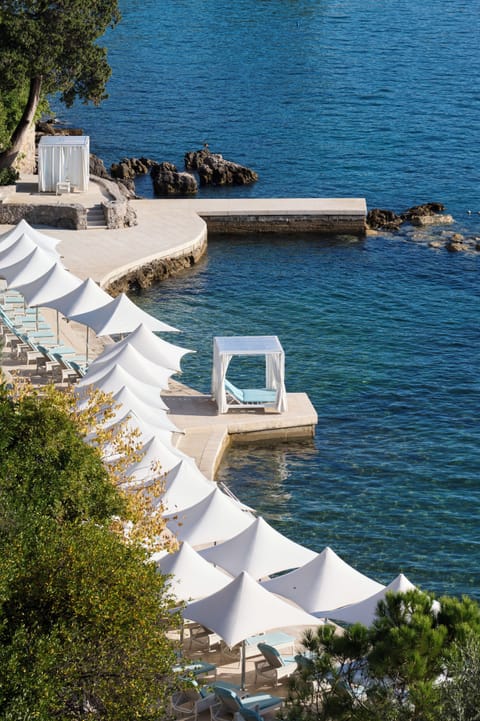 On the beach, sun loungers, beach umbrellas, beach towels