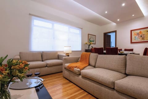 
The living room of our apartment welcomes you with two spacious couches, set against a backdrop of a large window that floods the space with an abundance of natural light. It's the perfect spot to unwind and bask in the warmth of the sun's gentle em