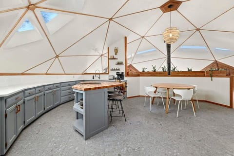 Complete with a geometric butcher block island and seating for 6.