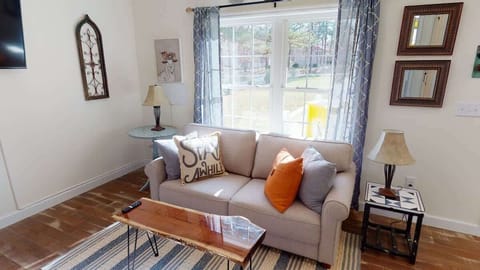 Relax on the super-comfy memory-foam sofa (folds out into a full-size bed) and enjoy the cozy electric fireplace and easy access to the front porch.