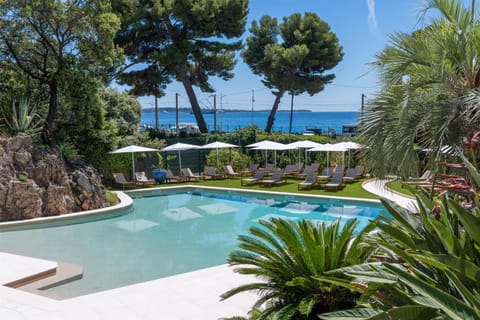 Seasonal outdoor pool, open 10:00 AM to 6:00 PM, pool umbrellas