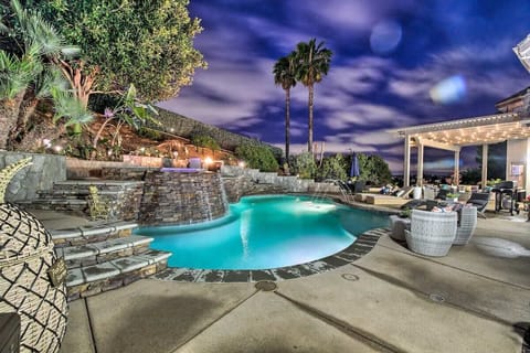 Dreamy pool with waterfall, hot tub & glowing lights—pure magic!