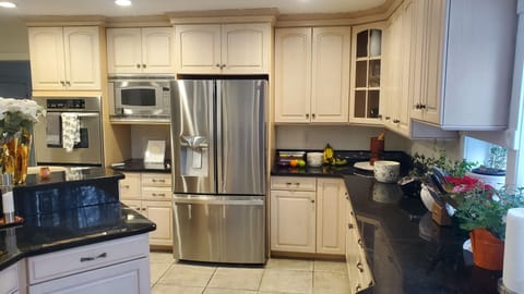 Kitchen with baking station, stainless steel double wall ovens, built-in microwa