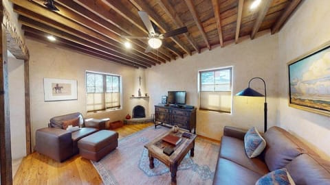 Cozy living room with Fire TV and wood burning kiva fireplace