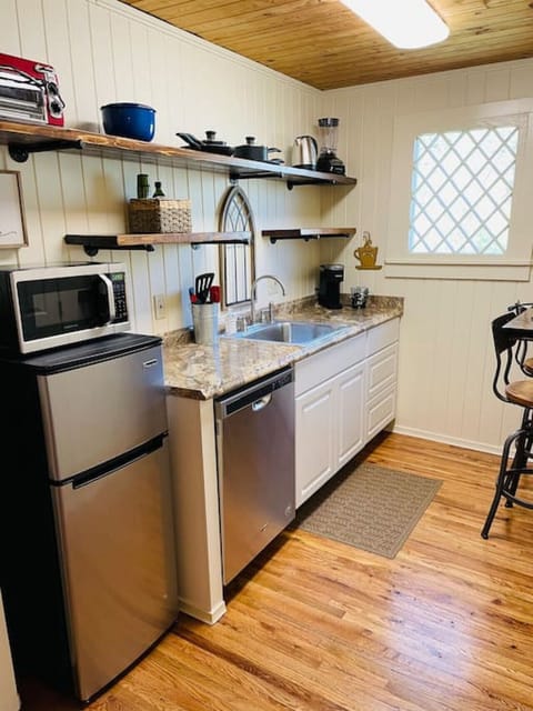 Kitchen complete with dishwasher, garbage disposal, microwave, refrigerator, Keurig, toaster oven, single burner hot plate, hot water kettle, blender,  dishes, pots & pans & utensils